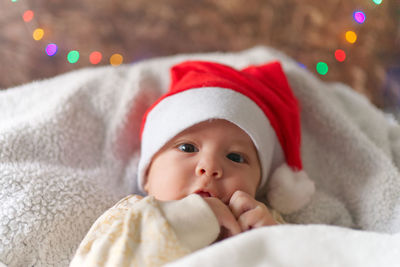 Close-up of cute baby boy sleeping on bed at home