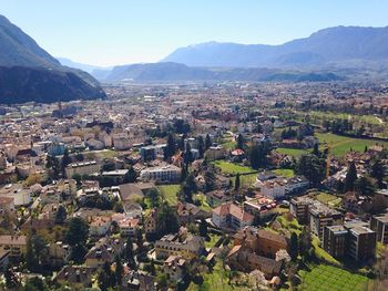 Townscape by mountains against clear sky