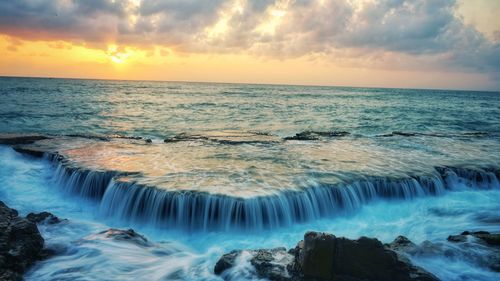 Scenic view of sea against sky during sunset