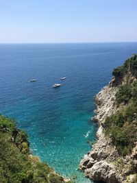 High angle view of sailboats on sea against clear sky