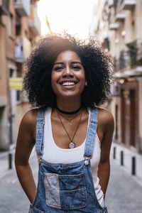 Smiling woman standing against buildings