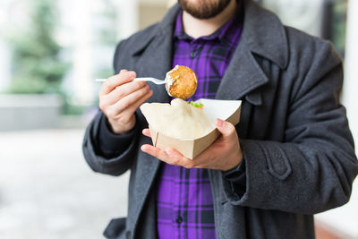 Midsection of man holding ice cream