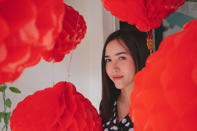 Portrait of woman with red flowers