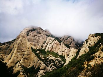 Low angle view of rock formations against sky