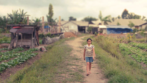 Girl walking on dirt road