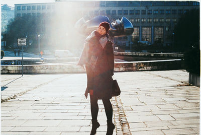 Full length of woman wearing warm clothing at park in city