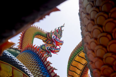  low angle twin stucco painted as a large serpent at pra kai keaw wang nakin, udon thani, thailand. 