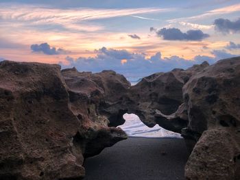 Rock formations against sky during sunset