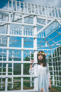 Full length of woman standing against building