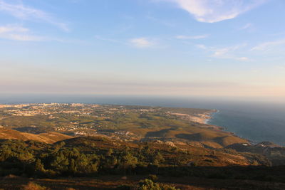 Aerial view of landscape against cloudy sky