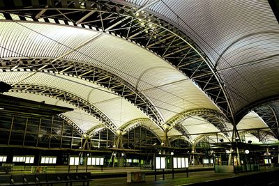 Low angle view of ceiling at illuminated leuven railway station