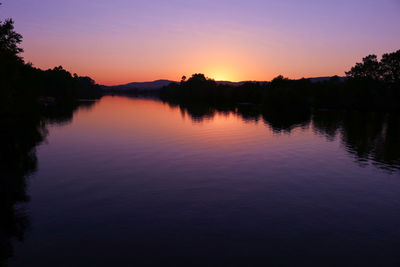 Scenic view of lake against romantic sky at sunset