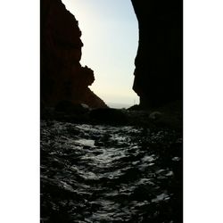 Rock formation in sea against sky