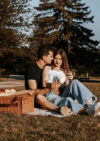 Young couple having a picnic in the park.