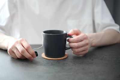 Close-up of hand holding coffee cup