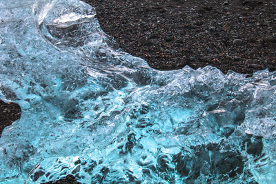 High angle view of water flowing through rocks