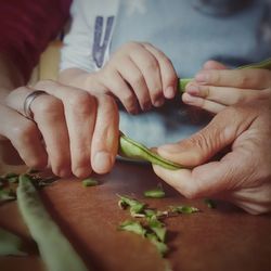 Close-up of man preparing food on cutting board