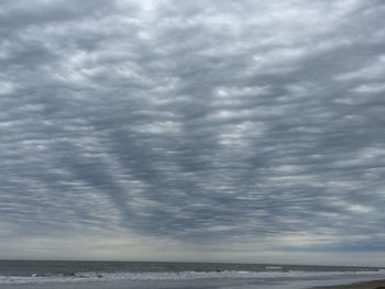 Scenic view of sea against storm clouds