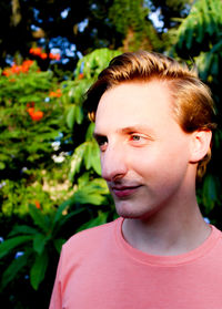 Close-up portrait of young man against plants