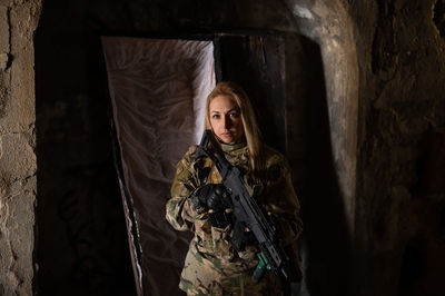 Portrait of woman standing against wall