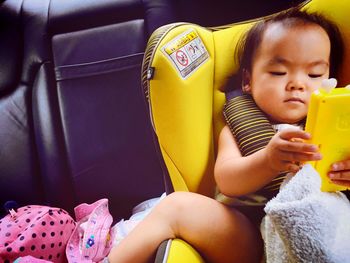 High angle view of toddler sitting in car