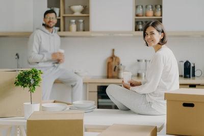 Smiling couple sitting at home