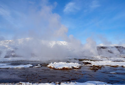 Hot water streams around strokkur geyser, iceland