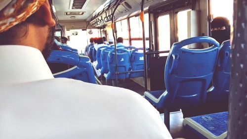 Rear view of man sitting in airplane