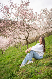 Portrait of young woman standing on field