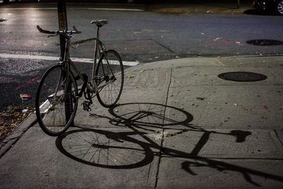 Close-up of bicycle on sidewalk