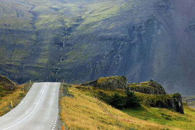 Panoramic view of country road amidst trees and mountains