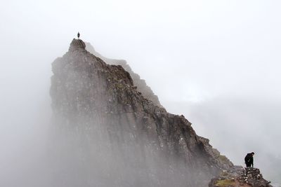 People walking on rocky peak