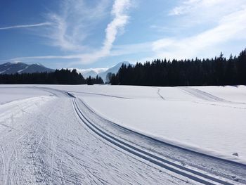 Scenic view of snow covered landscape against sky