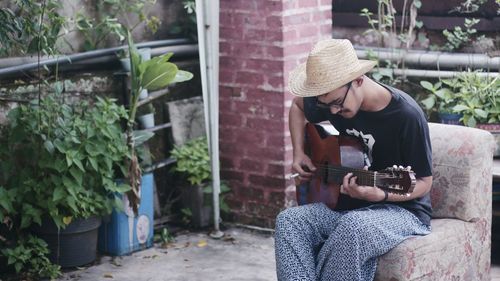 Man sitting and playing guitar