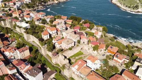 High angle view of townscape by sea