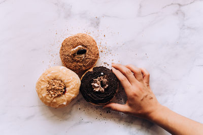 Cropped hand of woman holding cookies