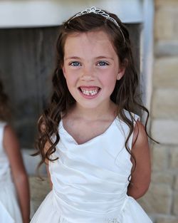 Portrait of girl smiling while standing outdoors