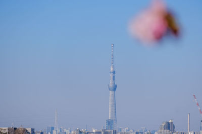 Low angle view of cityscape against clear blue sky