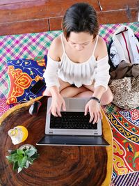 High angle view of woman using mobile phone at home