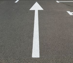 High angle view of arrow sign on road