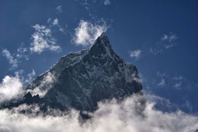 Low angle view of snowcapped mountains against sky