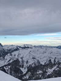 Scenic view of snow covered mountains against sky