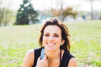 Portrait of smiling young woman in park