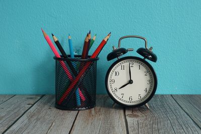 Close-up of clock on wooden table