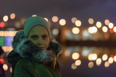 Close-up portrait of illuminated christmas tree in city during winter