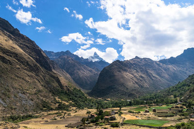 Scenic view of mountains against cloudy sky