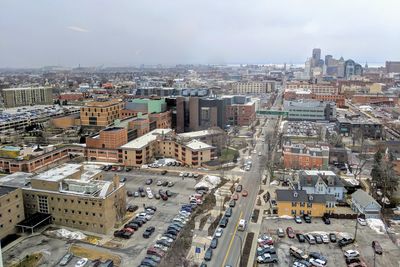 High angle view of vehicles on road amidst buildings in city