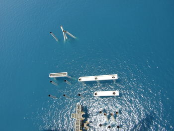 Aerial view of poles in sea