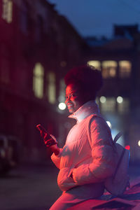 Side view of man using mobile phone