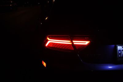 Close-up of illuminated car against sky at night